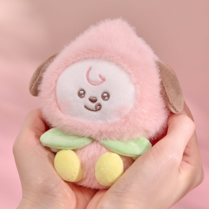 BT21 Peach Holic CHIMMY plush keyring held in two hands on a pink background