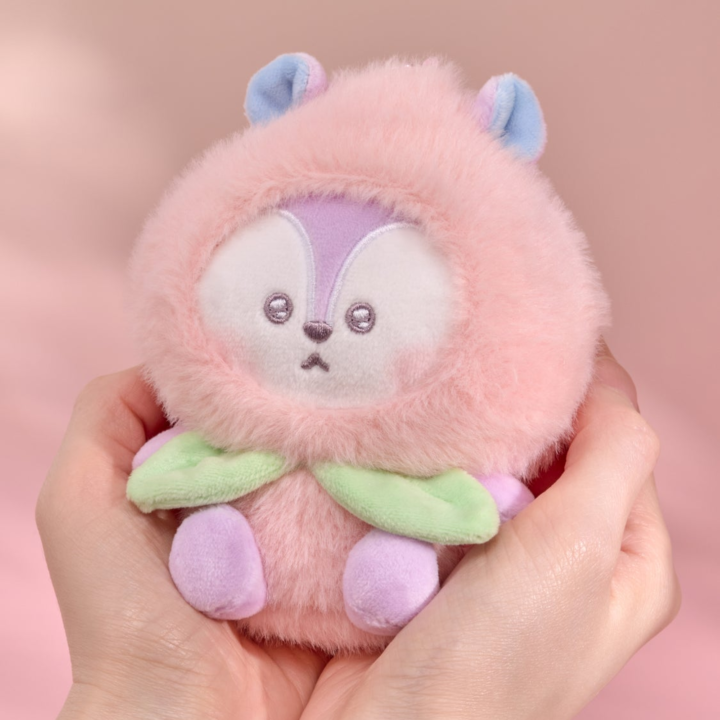 BT21 Peach Holic MANG plush keyring held in two hands on a pink background