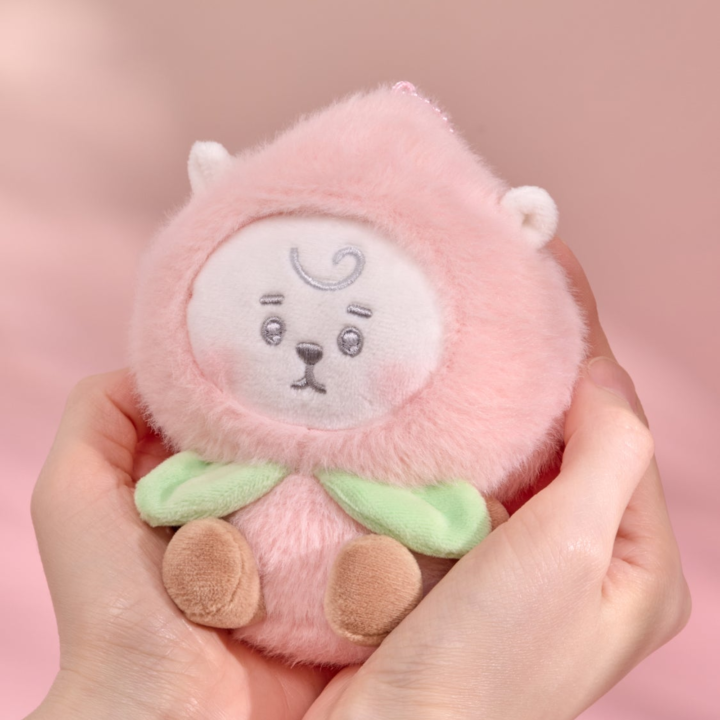 BT21 Peach Holic RJ plush keyring held in two hands on a pink background