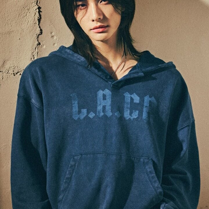 Hyunjin wearing the dark blue GUESS LA-CA hoodie