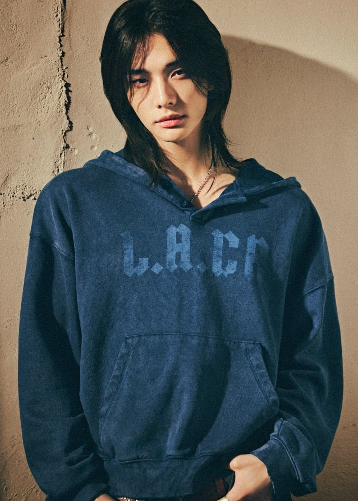 Hyunjin wearing the dark blue GUESS LA-CA hoodie